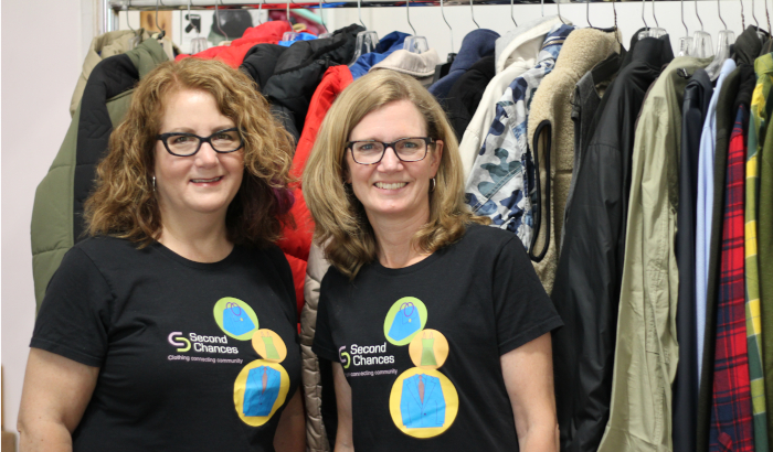 Andrea Shapiro (founder and CEO) and Jessica Callaghan (program manager) sort donations at Second Chances. Photo by Kat Rutkin.