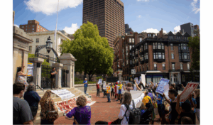 Protestors cheer at June 15, 2023 indigenous rights rally in front of the Mass State House as Jean-Luc Pierite gives a speech. Photo by Yaakov Aldrich. Copyright 2023 Yaakov Aldrich.