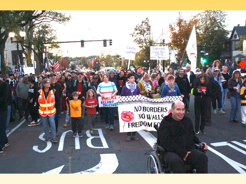 People marching on Broadway in East Somerville to support immigrants targeted by U.S. Immigration and Customs Enforcement on Oct. 21, 2025. Photo by C. Scott Morris. Copyright 2025 C. Scott Morris.